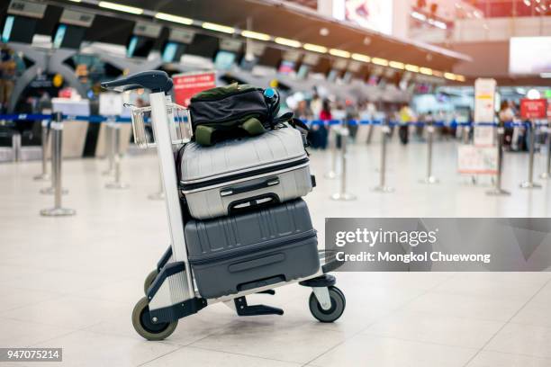 suitcase or baggage with airport luggage trolley in the international airport. - valise stock-fotos und bilder