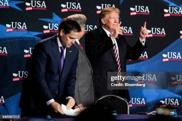 President Donald Trump gestures while music plays before the start of a roundtable discussion on tax cuts for Florida small businesses in Hialeah,...