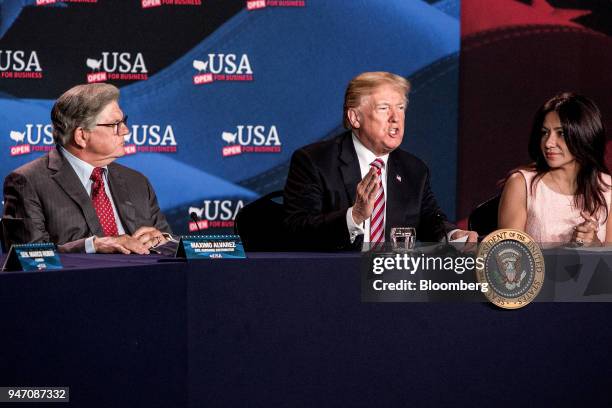 President Donald Trump, center, speaks while Maximo Alvarez, president of Sunshine Gasoline Distributors, left, and Irina Vilarino, owner of Las...