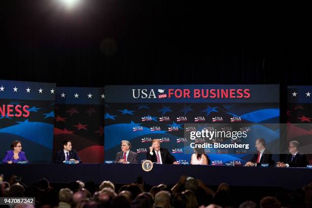 President Donald Trump, center, speaks during roundtable discussion on tax cuts for Florida small businesses in Hialeah, Florida, U.S., on Monday,...