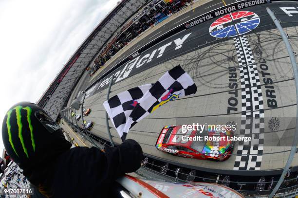 Kyle Busch, driver of the Skittles Toyota, takes the checkered flag to win the rain delayed Monster Energy NASCAR Cup Series Food City 500 at Bristol...