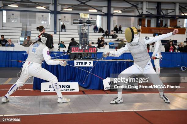 Tiffany Luong of NYU competes against Elyssa Kleiner of Notre Dame in the foil competition during the Division I Women's Fencing Championship held at...