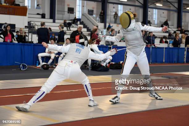 Tiffany Luong of NYU competes against Elyssa Kleiner of Notre Dame in the foil competition during the Division I Women's Fencing Championship held at...