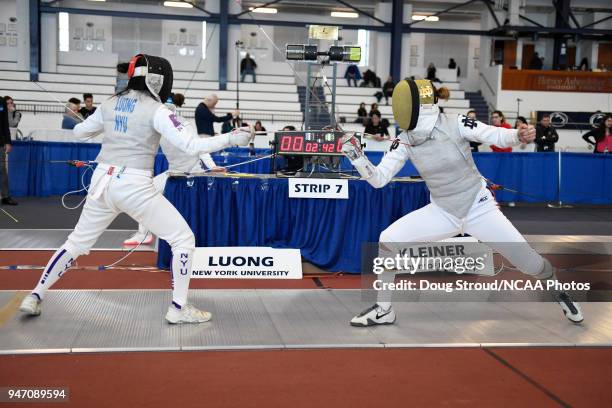 Tiffany Luong of NYU competes against Elyssa Kleiner of Notre Dame in the foil competition during the Division I Women's Fencing Championship held at...