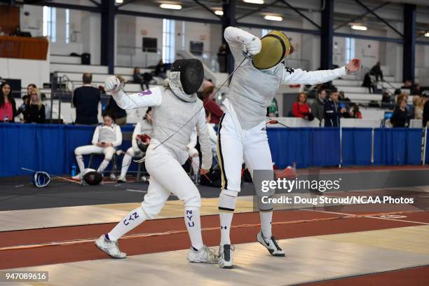 Tiffany Luong of NYU competes against Elyssa Kleiner of Notre Dame in the foil competition during the Division I Women's Fencing Championship held at...