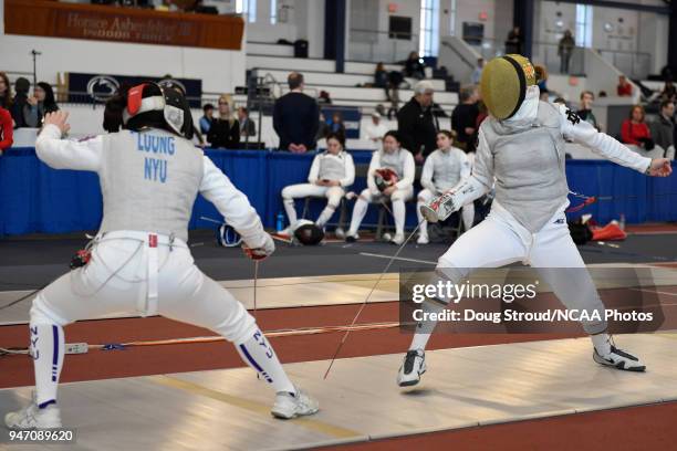 Tiffany Luong of NYU competes against Elyssa Kleiner of Notre Dame in the foil competition during the Division I Women's Fencing Championship held at...