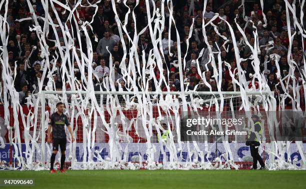 Stewards remove rolls of toilet paper thrown by fans during the Bundesliga match between 1. FSV Mainz 05 and Sport-Club Freiburg at Opel Arena on...