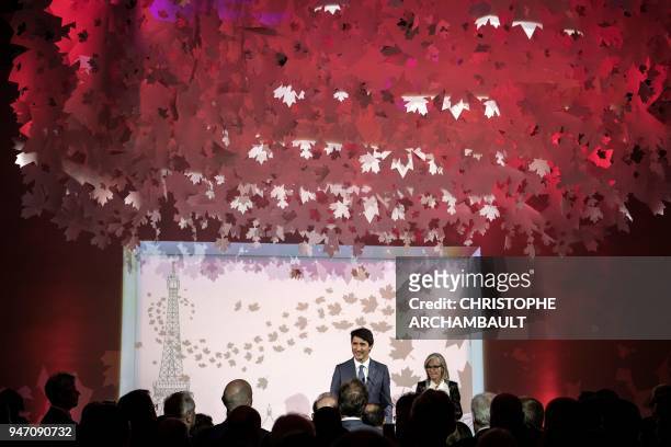 Canadian Prime Minister Justin Trudeau delivers a speech flanked by Canadian Ambassador to France Isabelle Hudon during the inauguration of the new...
