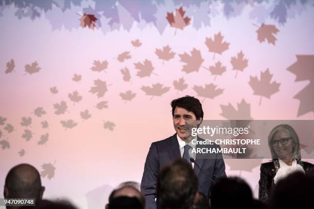 Canadian Prime Minister Justin Trudeau delivers a speech flanked by Canadian Ambassador to France Isabelle Hudon during the inauguration of the new...