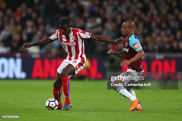 Kurt Zouma of Stoke City and Joao Mario of West Ham United battle for possession during the Premier League match between West Ham United and Stoke...