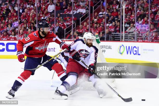 Brett Connolly of the Washington Capitals and Ian Cole of the Columbus Blue Jackets battle for the puck in the first period in Game Two of the...