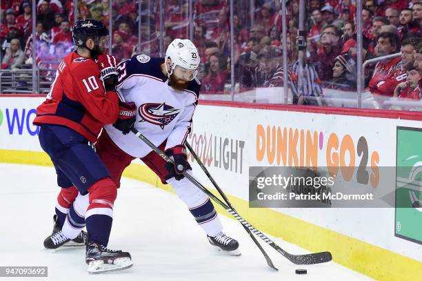 Ian Cole of the Columbus Blue Jackets and Brett Connolly of the Washington Capitals battle for the puck in the first period in Game Two of the...