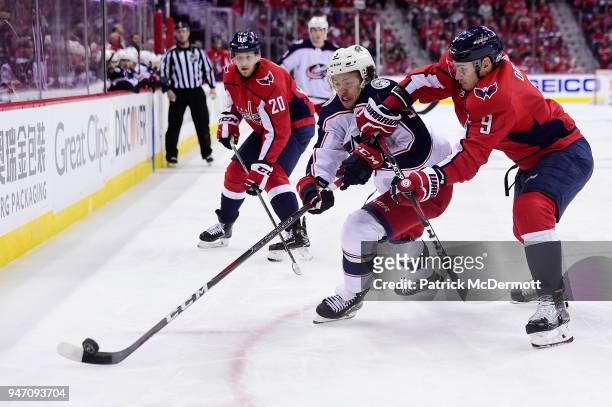 Dmitry Orlov of the Washington Capitals and Artemi Panarin of the Columbus Blue Jackets battle for the puck in the second period in Game Two of the...