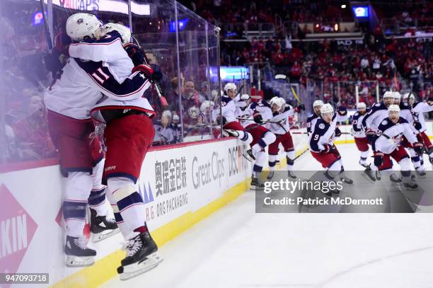 Matt Calvert of the Columbus Blue Jackets celebrates with his teammates after scoring the game-winning goal in overtime against the Washington...