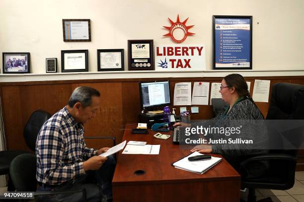 Liberty Tax Service tax specialist Laura Tuuri helps a client do his taxes on April 16, 2018 in Oakland, California. Taxpayers who have...