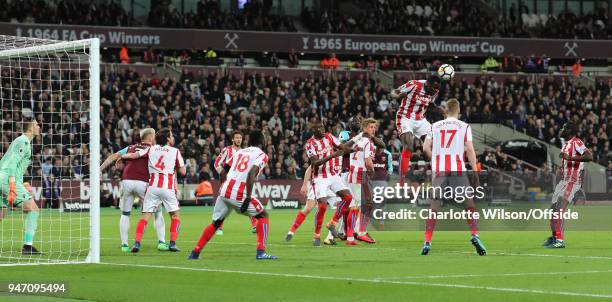 Kurt Zouma of Stoke heads the ball clear from a packed penalty area during the Premier League match between West Ham United and Stoke City at London...