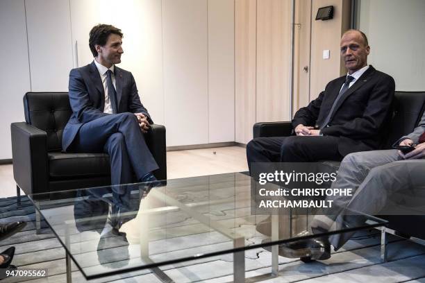 Canada's Prime Minister Justin Trudeau speaks with Airbus CEO Tom Enders during a meeting at the newly-opened Canadian Embassy as part of his...