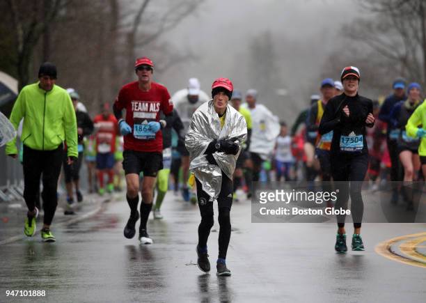 Runners climb Heartbreak Hill during the Boston Marathon in Newton, Mass., April 16, 2018.