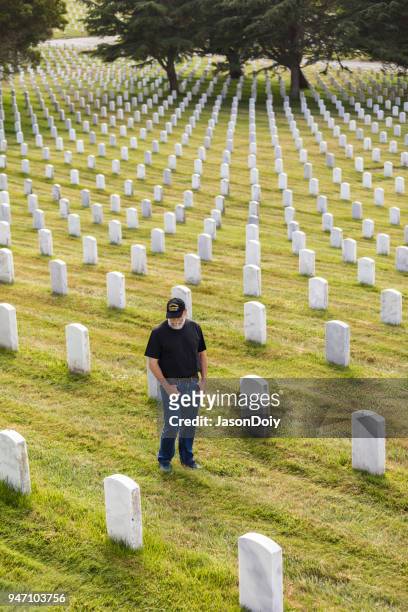 authentic vietnam veteran walking in military cemetary - jasondoiy stock pictures, royalty-free photos & images