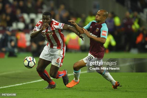 Kurt Zouma of Stoke City and Joao Mario of West Ham United battle for possession during the Premier League match between West Ham United and Stoke...