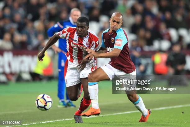 Stoke City's Kurt Zouma and West Ham United's Joao Mario battle for the ball during the Premier League match at London Stadium.