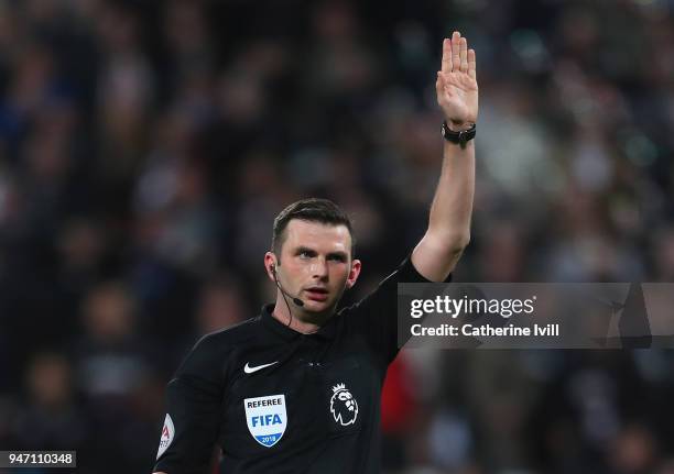 Referee Michael Oliver reacts during the Premier League match between West Ham United and Stoke City at London Stadium on April 16, 2018 in London,...