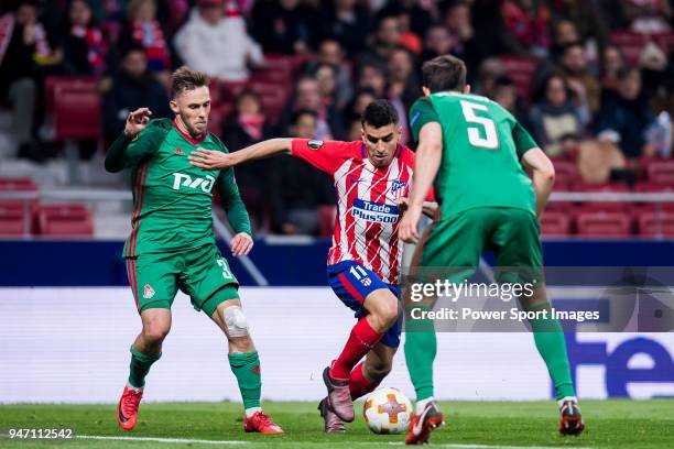 Angel Correa of Atletico de Madrid competes for the ball with Maciej Rybus of FC Lokomotiv Moscow during the UEFA Europa League 2017-18 Round of 16...