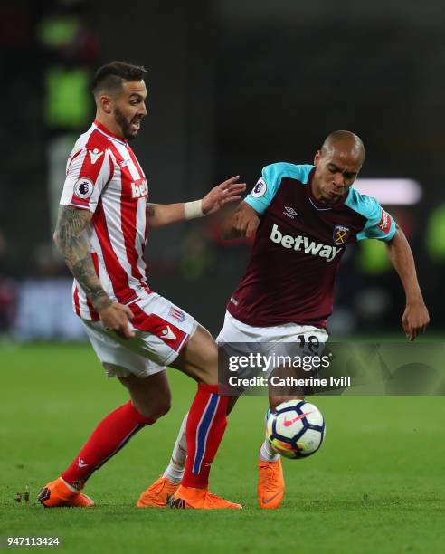 Geoff Cameron of Stoke City and Joao Mario of West Ham United battle for possession during the Premier League match between West Ham United and Stoke...