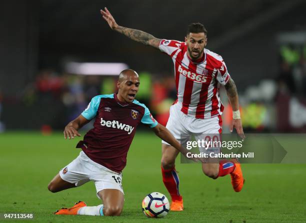 Geoff Cameron of Stoke City and Joao Mario of West Ham United battle for possession during the Premier League match between West Ham United and Stoke...