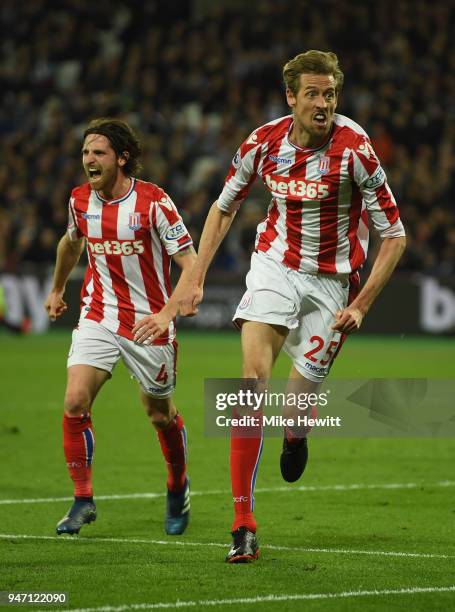 Peter Crouch of Stoke City celebrates with team mate Joe Allen of Stoke City after scoring his sides first goal during the Premier League match...