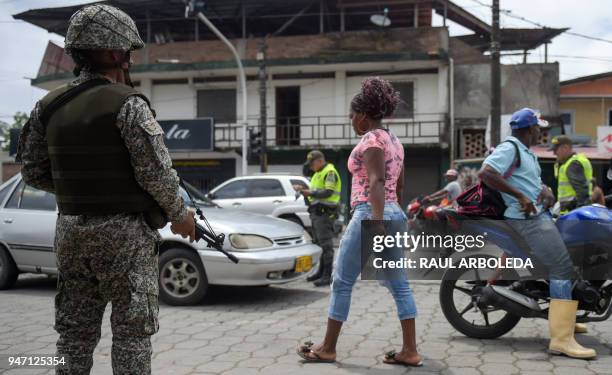 Colombian marine and police officers patrol the streets of Tumaco, a municipality in the Colombian department of Narino near the border with Ecuador,...