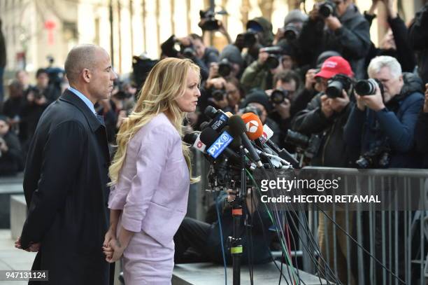 Adult-film actress Stephanie Clifford, also known as Stormy Daniels speaks to the media next to her lawyer Michael Avenatti, after a court hearing...