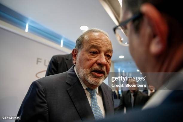 Carlos Slim, chairman emeritus of America Movil SAB, speaks with an attendee during a press conference in Mexico City, Mexico, on Monday, April 16,...
