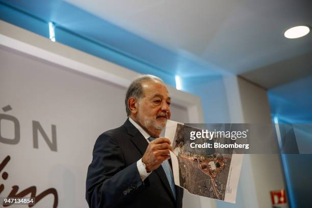 Carlos Slim, chairman emeritus of America Movil SAB, holds up an image of the New International Airport of Mexico City during a press conference in...