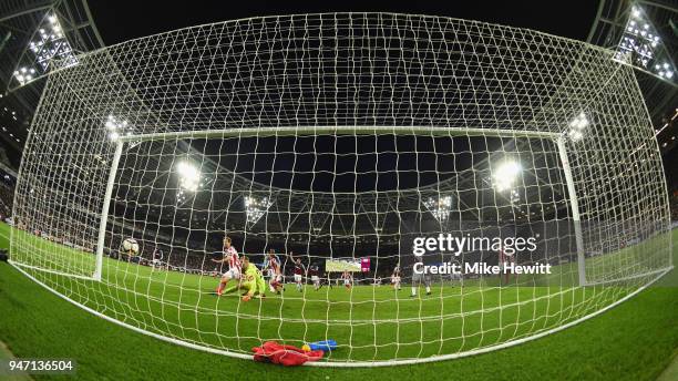 Peter Crouch of Stoke City scores his sides first goal past Joe Hart of West Ham United during the Premier League match between West Ham United and...
