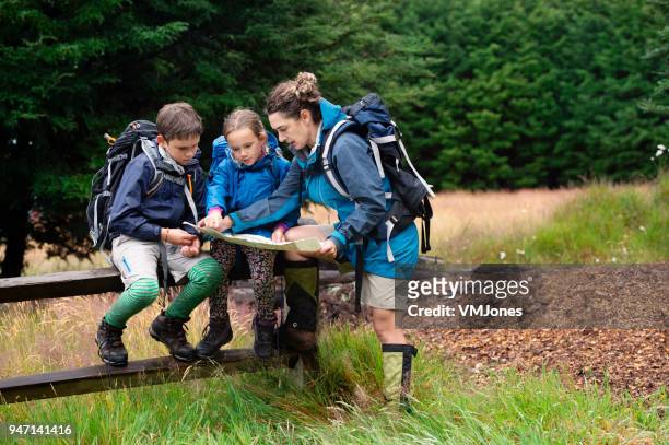 new zealand family following map in national park - following map stock pictures, royalty-free photos & images