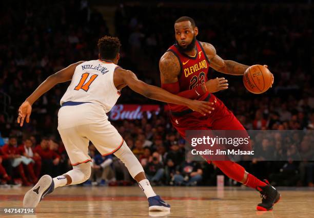 LeBron James of the Cleveland Cavaliers in action against Frank Ntilikina of the New York Knicks at Madison Square Garden on April 9, 2018 in New...