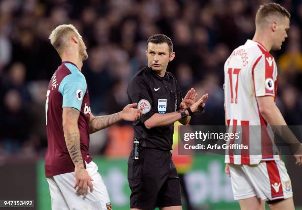 Marko Arnautovic of West Ham United disagrees with referee Michael Oliver during the Premier League match between West Ham United and Stoke City at...