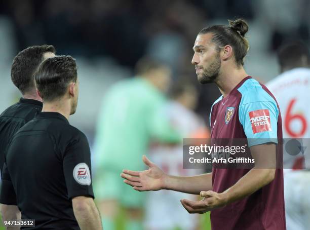 Andy Carroll of West Ham United disagrees with referee Michael Oliver during the Premier League match between West Ham United and Stoke City at...