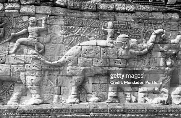 Detail of a bas-relief depicting a procession of elephants decorating the Bayon temple, built in the 13th century in Khmer style. Angkor, 1960s