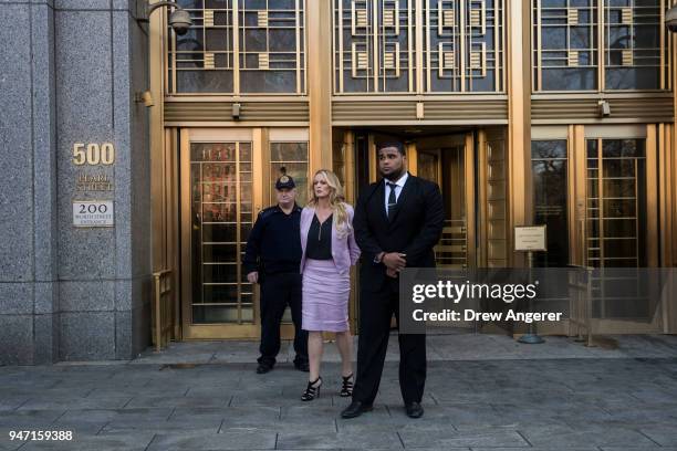 Adult film actress Stormy Daniels speaks to reporters as she exits the United States District Court Southern District of New York for a hearing...