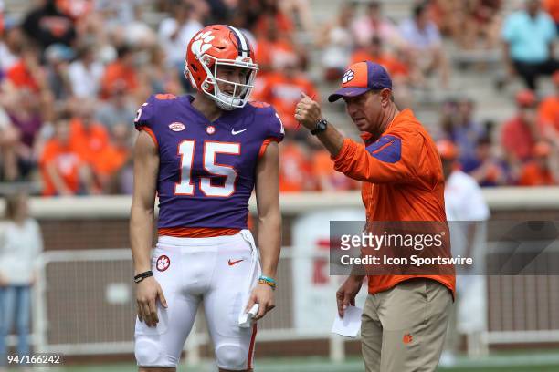 Hunter Johnson listens to head coach Dabo Swinney between plays at the Clemson Spring Football game at Clemson Memorial Stadium on April 14, 2018 in...