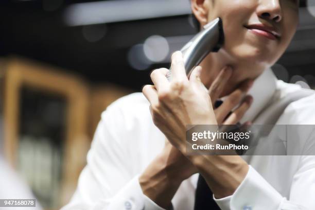 close up of man using hair clipper - hair clipper stock pictures, royalty-free photos & images