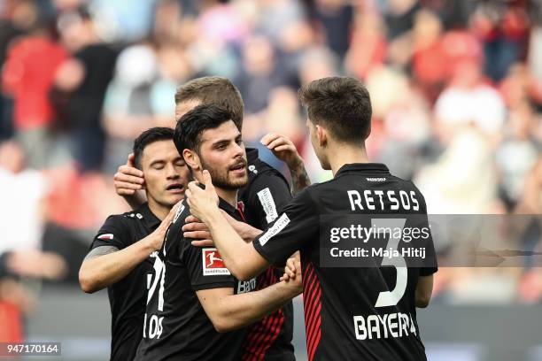 Charles Aranguiz of Bayer Leverkusen , Kevin Volland and Panagiotis Retsos of Bayer Leverkusen celebrate after the Bundesliga match between Bayer 04...