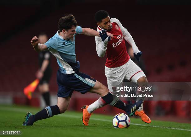 Trae Coyle of Arsenal is challenged by Tom Williams of Blackpool during the match between Arsenal and Blackpool at Emirates Stadium on April 16, 2018...