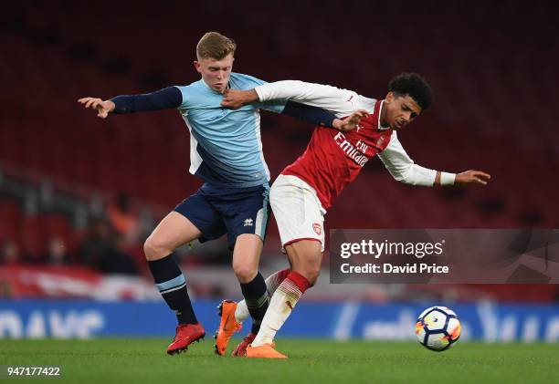 Xavier Amaechi of Arsenal takes on Rowan Roache of Blackpool during the match between Arsenal and Blackpool at Emirates Stadium on April 16, 2018 in...