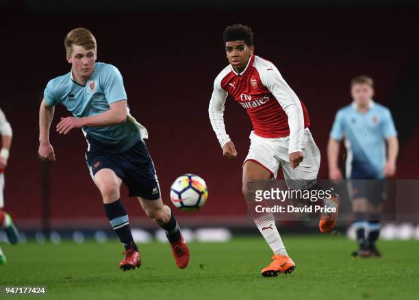 Tyreece John-Jules of Arsenal takes on Will Avon of Blackpool during the match between Arsenal and Blackpool at Emirates Stadium on April 16, 2018 in...