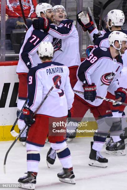 Columbus Blue Jackets left wing Matt Calvert is hugged by captain left wing Nick Foligno after scoring the game winning goal in overtime against the...