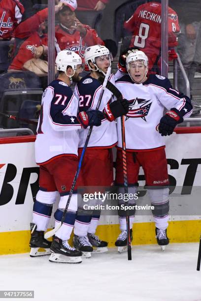 Columbus Blue Jackets left wing Matt Calvert is hugged by defenseman Ryan Murray and captain left wing Nick Foligno after scoring the game winning...