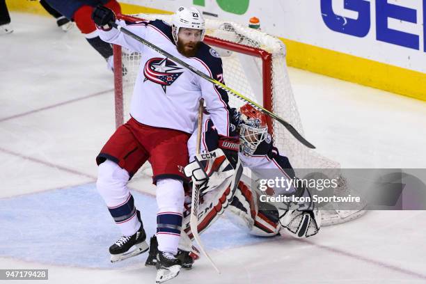 Columbus Blue Jackets defenseman Ian Cole trips over goaltender Sergei Bobrovsky in the second period on April 15 at the Capital One Arena in...